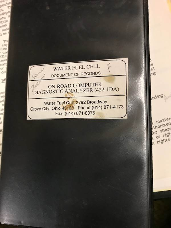 The binder cover: "WATER FUEL CELL / DOCUMENT OF RECORDS / ON-ROAD COMPUTER DIAGNOSTIC ANALYZER (422-1DA) / Water Fuel Cell, 3792 Broadway, Grove City, Ohio 43123; Phone (614) 871-4173; Fax: (614) 871-8075". Initials and a date are pencilled on the label.